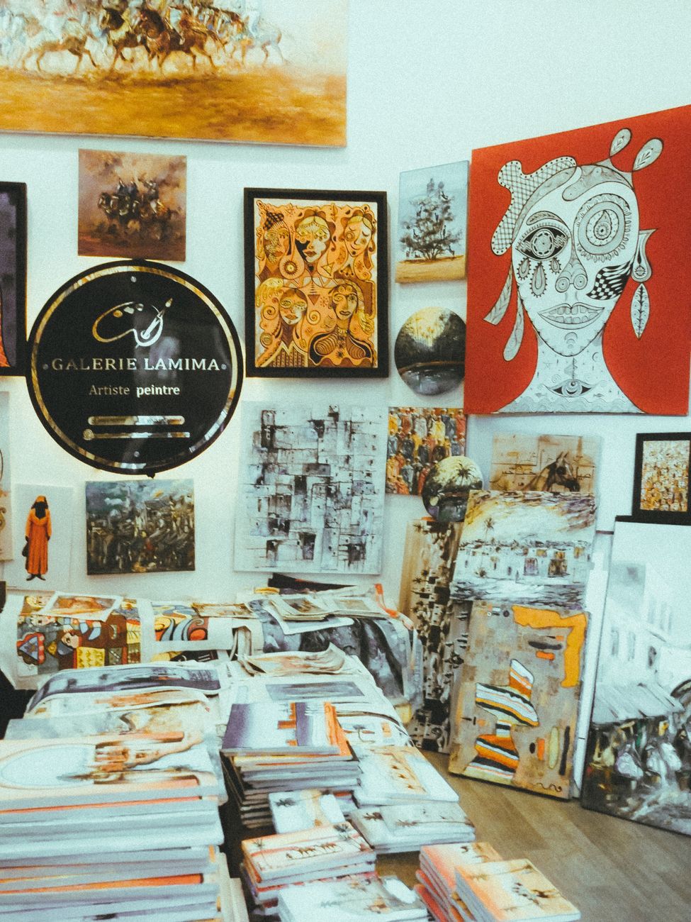 Curated fine arts canvases displayed on studio floor for matching design